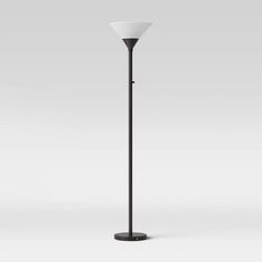 a black and white floor lamp on a gray background