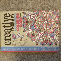 a coloring book sitting on top of a carpet