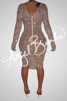 This dress radiates elegance and style with its rhinestone adornment of unique shapes and colors. Constructed from a nude mesh material with moderate stretch, long sleeves and a low-cut zipper up the back, you'll be sure to make an unforgettable impression. As this material is delicate, handle with care when putting on and taking off. Ideal for a night out with friends or a luxurious dinner, you'll be guaranteed to look and feel your best. - All mesh dress embellished with Rhinestone - All stone Club Dresses With Sheer Long Sleeves, Glamorous Long Sleeve Sheer Mesh Dress, Glamorous Fitted Mesh Dress With Sheer Sleeves, Glamorous Long Sleeve Mini Dress With Back Zipper, Long Sleeve Embellished Club Dresses, Stretch Mesh Long Sleeve Dress For Cocktail, Stretch Mesh Long Sleeve Cocktail Dress, Stretch Long Sleeve Mesh Dress For Cocktail, Embellished Stretch Bodycon Dress With Long Sleeves