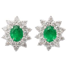 An elegant pair of certified Colombian Emerald and Diamond Earrings 4.93 carats of "VIVID GREEN" fine Colombian Emeralds 4.88 carats of round brilliant cut white diamonds. Set in 18k white gold These earrings are certified by Christian Dunaigre of Switzerland Approximately 22.5 mm x 19mm. Emerald And Diamond Earrings, Emerald Diamond Earrings, Sapphire And Diamond Earrings, Diamond Cluster Earrings, Platinum Earrings, Swirl Earrings, Colombian Emeralds, Diamonds And Gold, Emerald Earrings