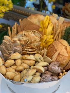 a bowl filled with lots of different types of food on top of a white table