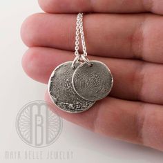 "Your actual Finger print or thumb print preserved forever in pure silver as a wearable keepsake. Each piece comes with a sterling silver, 22\" adjustable chain. Choose from either a small (16mm/.5\") or large (21mm/.75\") fingerprint circle. Each orders comes with a sterling silver, 22\" adjustable cable chain. Layer and stack multiple necklaces! Each piece includes 3 letters or initials engraved on the reverse. More engraving can be added (as long as it will fit on the charm) however, there wo Minimalist Hand Stamped Keepsake Jewelry, Minimalist Hand Stamped Memorial Jewelry, Minimalist Etched Jewelry For Keepsake, Thumbprint Necklace, Multiple Necklaces, Thumb Print, Fingerprint Necklace, Thumb Prints, Clever Gift