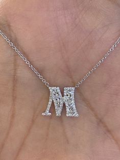 Letter M diamond initial pendant white gold.  Set with nice and very sparkling diamonds.  Excellent craftsmanship, the diamonds are clean.  You will love how sparkly these diamonds are.  Very simple and pretty pendant to wear on the neck or put it on a charm bracelet.  Diamonds are set smooth.  M measures about 10.5 x 13.1mm.  Lays nicely on, won't flip around. Genuine earth mined Round Brilliant Cut Diamonds Total Weight: 0.44 Carats Clarity: SI Color: F 77 diamonds  18K White gold 3.55 grams  Comes with gift box  * We have been in the wholesale Jewelry business for over 30 years serving the community at the same location.  All diamonds we use are natural stones and fine quality gold.  Absolutely NO clarity enhanced or treated diamonds. Our jewelry pieces are handcrafted with fine craftsm Dazzling Sparkling Diamond Necklace, Sparkling Diamond Pendant Necklace, Diamond White Sparkling Diamond Necklace, Sparkling Diamond White Diamond Necklace, White Diamond Personalized Jewelry, White Diamond Jewelry With Initials, White Gold Diamond Necklace With Initials For Anniversary, Sparkling Diamond White Pendant Necklace, Dazzling White Diamond Necklace With Accents