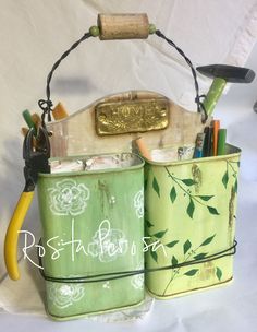 a green tin can with some writing utensils in it