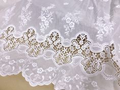 white lace with gold foiling on it