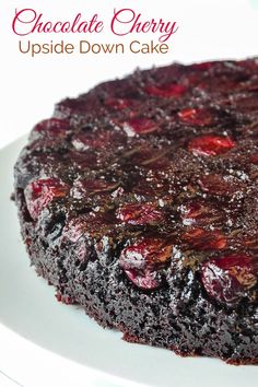 a chocolate cherry upside down cake on a white plate with the words, chocolate cherry upside down cake