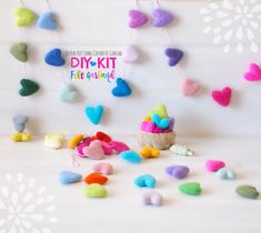 colorful felt hearts hanging from strings on a white background with text overlay that reads diy kit felt heart garland