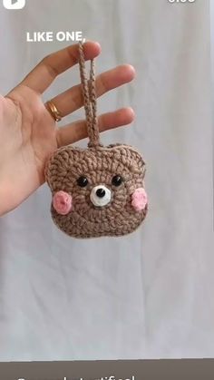 a hand is holding a small crocheted animal ornament in it's palm