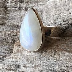 "Moonstone ring set in sterling silver bezel comes as blue flash teardrop gemstone healing statement jewelry for men and women. It measures apx. 25 mm in length and 15 mm in width. Natural finest grade untreated raw Rainbow Moonstone with a lovely blue fire flash  Open back to allow the gemstone healing energies to its wearer  Designed to suit all age and gender, in a crystal associated with 'the Moon'...Suitable gift for all occasions...Anniversary gift Birthday gift , engagement ring jewelry, wedding gift hallmark 925.  Size 9.5 Healing- Rainbow moonstone is a gemstone for \"New beginnings\", inner growth and strength. It soothes emotional instability and stress, and stabilizes the emotions, providing calmness.  Moonstone enhances intuition, promotes inspiration, success and good fortune Adjustable Dainty Moonstone Jewelry, Adjustable Teardrop Jewelry With Natural Stones, Adjustable Teardrop Natural Stone Jewelry, Adjustable Moonstone Jewelry Gift, Adjustable Moonstone Jewelry For Gift, Fine Jewelry With Cabochon Drop, Fine Jewelry Drop Cabochon, Bohemian Silver Drop Jewelry, Cabochon Drop Jewelry For Gifts