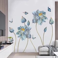 a living room with blue flowers and butterflies on the wall