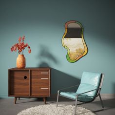 a room with a chair, table and vase on the floor next to a blue wall