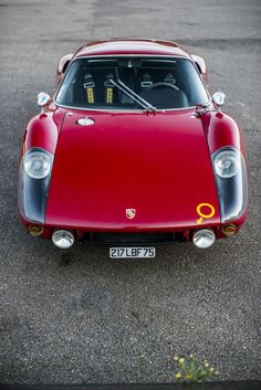 a red sports car parked in a parking lot