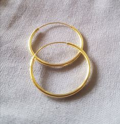 The absolute classic: the Creole, always elegant and beautiful! Material: 925 sterling silver gold plated Diameter: 25mm, Hollow Wire Thickness: 1.5mm Closure: the classic sliding closure Shape: round Please note: These classic hoop earrings are made of a hollow wire. To close it, the thinner wire must be pulled through the earlobe and then inserted into the hollow wire. If the creole stays in the ear for a long time, this clasp is very suitable because the earrings do not come open quickly, whi Classic Small Hoop Jewelry For Gifts, Classic Small Hoop Jewelry For Gift, Adjustable Tarnish Resistant Round Band Jewelry, Classic Gold Plated Hoop Earrings Gift, Small Hoop 14k Gold Jewelry, Yellow Gold Rounded Earrings For Gift, 14k Gold Small Hoop Jewelry, Gold Tarnish-resistant Rounded Earrings, Yellow Gold Earrings Gift