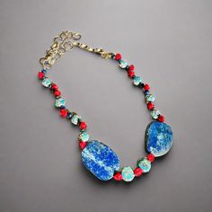 This unique necklace features coral, turquoise, and lapis luzi stones on an adjustable sterling silver chain. Each piece is one of a kind due to the natural variation in the stones. With its bright colors of blue, red, and white, it's the perfect design to make a statement and elevate any outfit. Let this bold accessory be the life of the party and take your look from 0 to 100 in no time! Part of the Bohemian collection, this necklace is a must-have for risk-takers and adventurers alike. 18 inch Bohemian Turquoise And Red Coral Necklaces, Bohemian Multi-strand Turquoise Gemstone Necklace, Multicolor Bohemian Multi-stone Necklace, Multicolor Multi-stone Bohemian Necklace, Blue Multi-stone Bohemian Turquoise Necklace, Bold Accessories, Unique Necklaces, Sterling Silver Chains, Coral