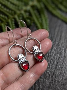 Rose cut garnet heart shaped gemstones set in a sterling silver serrated bezel with  hammered hoops and a skull .  The ear wires are handcrafted out of sterling silver wire.  Oxidized to give a antique finish. Garnet Heart, Hoops Silver, Red Love Heart, Red Love, Garnet Jewelry, Garnet Earrings, Earrings Red, Skull Earrings, Antique Finish