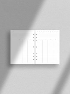 a white planner is hanging on the wall