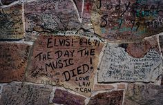 the wall is covered with graffiti and other writing on it's sides, including words that read elvis hut at the day the music died