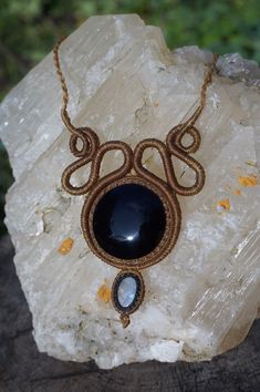 This necklace is made with our hands with the macramé technique using very durable waxed thread. We have set a black Obsidian from Mexico, specifically purchased in Teotihuacán, through a family and fair trade. The design also contains a rainbow Moonstone to give light to the jewel and enjoy its unique properties. Each necklace is complemented with a personally written micro story, based on a poetic interpretation of the properties of the stones with which we try to connect with the person who w Black Macrame Jewelry For Festivals, Black Bohemian Jewelry With Adjustable Cord, Bohemian Black Jewelry With Adjustable Cord, Bohemian Black Macrame Necklace, Black Bohemian Crystal Gemstone Necklaces, Handmade Adjustable Black Crystal Necklace, Black Bohemian Crystal Necklace With Gemstone, Black Bohemian Crystal Gemstone Necklace, Adjustable Handmade Black Crystal Necklaces