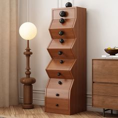 a tall wooden shelf sitting next to a lamp on top of a hard wood floor