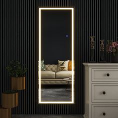 a living room with a couch and a large lighted mirror in it's corner