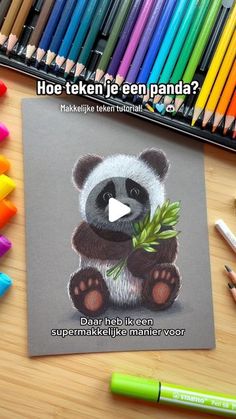 a drawing of a panda bear holding a bamboo plant in front of colored crayons