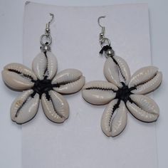 The Cowrie Shell Was Used As The First Form Of Currency In Africa. These Shells Have Been A Customer Favorite For 17 Years. These Earrings Are Fun, Playful And A Nice Accent To Any Outfit. Origin Of Beads: Kenya Elegant Flower-shaped Beach Earrings, Flower-shaped Earrings For Beach In Summer, White Flower Jewelry For Vacation, Bohemian Beach Jewelry With Handmade Flowers, Bohemian Flower Earrings For Vacation, Handmade Flower Jewelry For Vacation, Bohemian Handmade Flower Jewelry For Beach, Elegant Flower Shaped Earrings For Beach, Bohemian Beach Earrings With Handmade Flowers