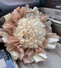 a bouquet of roses is sitting in the front seat of a car