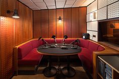 a room with two microphones sitting on top of a round table in front of speakers