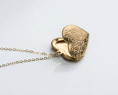 "Super pretty floral heart locket includes tiny vintage raised flowers. Model is wearing a 18\" (shortest in photos), 24\" (mid length rose) and 30\" (long) chain. Available in rose and silver plated as well as solid golden raw brass. D E T A I L S : -Pendant is solid raw brass or silver platd or rose plated -Made from a vintage mold -Chain is 14kt gold fill, sterling silver or 14kt rose fill depending on your choice in the drop down menu -Need more? Just convo us, we may have multiples availabl Mother Heart, Necklace For Mother, Heart Shaped Locket, Birthday Necklace Gift, Engraved Locket, Valentine Gifts For Girlfriend, Rose Heart, Rosé Heart, Heart Locket Necklace