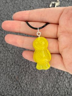 This adorable necklace will help you stand out anywhere you go with its vibrant colour and super sparkly finish.  This adorable jelly baby is made from epoxy resin filled with yellow mica powder and yellow glitter.  Measures approx. 2cm x 3.5cm x 1cm Epoxy Resin Necklace, Jelly Babies, Yellow Glitter, Resin Necklace, Mica Powder, Handmade Baby, Epoxy Resin, Jelly, Jewelry Necklace Pendant