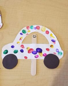 a paper plate with a car made out of it and some scissors on the table