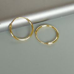 IMPORTANT **Please go through all the pictures i have posted for a listing with a ruler, on a model, on my hand, to get an exact idea of the actual size of the item. 14mm sterling silver endless ear hoops, plated in gold. Size: 1.2 x 14 mm Gauge: 16 These earrings are made of real 925 hypoallergenic sterling silver, dipped in real gold. Price listed is for ONE PAIR of hoops. These earrings are made of 925 hypoallergenic sterling silver and comes with a 925 stamp. Can be packaged in a gift box. I Dainty Gold Hoop Cartilage Earrings, Gold Hypoallergenic Hoop Cartilage Earrings, Gold Hypoallergenic Small Hoop Nose Rings, Gold Hypoallergenic Round Cartilage Earrings, Gold Sterling Silver Hoop Nose Rings, Dainty Hypoallergenic Hoop Cartilage Earrings, Hypoallergenic Small Hoop Gold Nose Rings, Gold Adjustable Small Hoop Nose Ring, Gold Hoop Cartilage Earrings In Sterling Silver