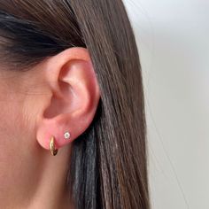 The Gold Dome Huggie Earring is a unique spin on a traditional huggie, thanks to its dome-like silhouette. Crafted from 14k gold, this huggie is perfect for everyday wear and looks just as good in the lobe as it does higher up the ear. Round Ear Free Lobe Piercings, Two Piercings Ear Ideas, 2 Piercings Ear Ideas, Ear Pricing, 2nd Ear Piercing, Double Ear Piercing, Double Piercing Earrings, Double Ear Piercings, Earring Stack