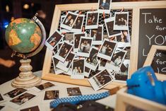 a table topped with pictures and a globe