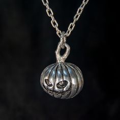 Here is one especially adorable dark item, a carved pumpkin pendant made out of metal. An ideal gift for the coming holidays to surprise a loved one or a local goth or metalhead person. Get them this cute grinning creature and watch them smile as they see this exquisite piece. It will definitely stand out in any crowd and draw all kinds of attention. The entire necklace is made out of aluminium, a very stable and durable metal that never loses it's shine, and is light weight enough to not be a s Gothic Nickel-free Necklace For Halloween, Gothic Nickel-free Necklaces For Halloween, Gothic Round Pendant Necklace For Halloween, Gothic Halloween Jewelry With Round Pendant, Gothic Halloween Round Pendant Jewelry, Gothic Hand-cast Halloween Necklaces, Silver Halloween Charms Necklace, Silver Charms Necklace For Halloween, Sterling Silver Charms Necklace For Halloween