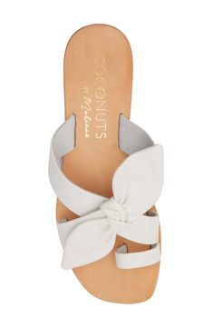 An oversized bow accents the upper of this chic toe-loop sandal fashioned from supple leather with light traction on the sole. Leather upper/synthetic lining and sole Imported Synthetic Sandals With Bow And Round Toe, White Sandals With Heel Loop For Vacation, Bow Sandals With Round Toe For Vacation, Synthetic Sandals With Bow And Flat Heel, Round Toe Sandals With Bow In Synthetic Material, Spring Toe Loop Sandals With Wrapped Heel, Beach Sandals With Bow And Round Toe, Spring Bow Strap Sandals With Round Toe, Spring Sandals With Bow And Round Toe