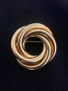 "This bold and beautiful brooch features layers of entwined circles. It is 2 inches across. If you Google \"Brooches 2023\" you will see that brooches are a design trend for this year. I love to wear a brooch like this on a solid colored dress, chunky sweater, or as a scarf pin.  All items in my shop are perfect for gifting- I clean every item, it comes in a gift box lined with cotton, and includes a card indicating it's vintage so the recipient knows more about the piece. Every item purchased from my shop comes with a free surprise gift and free shipping in the United States." Wear A Brooch, Scarf Pin, Bold And Beautiful, Surprise Gift, Vintage Brooch, Me Clean, Chunky Sweater, Surprise Gifts, Vintage Brooches