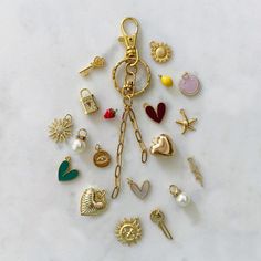 a bunch of different types of charms on a white surface with one charm attached to the other