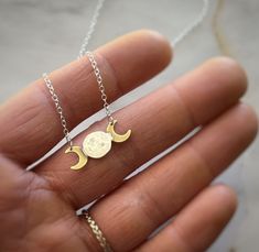 Capture the beauty and mystery of the night sky with our celestial-inspired moon phase necklace The pendant showcases a harmonious blend of metals with a solid .925 silver chain anchored to a centerpiece crafted from two polished brass crescent moons framing a handcrafted silver full moon at its heart. The center of the pendant holds a silver moon that's been carefully crafted by melting and hammering the metal by hand. The resulting shape and texture are wonderfully imperfect, creating a unique Centerpiece Craft, Moon Phases Necklace, Artisan Necklace, Silver Moon, The Night Sky, Moon Phases, Crescent Moon, Polished Brass, Full Moon