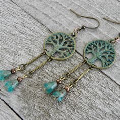 "If you are down to earth and prefer the simple life these woodland beaded dangle earrings are just for you. The turquoise green patina brass tree of life charms provides an earthy contrast to the faceted Czech glass teardrop beads. Your spirits are guaranteed to be lighten with these soulful handmade earrings that sway harmoniously with movement.   Earrings are measured from the base of the earwire 4 Small pairs in stock - 17 x 20mm Tree of Life Charm and 1 5/8\" in length 2 Large pairs in stoc Handmade Nature-inspired Dangle Beaded Earrings, Nature-inspired Beaded Dangle Earrings As Gift, Earthy Beaded Dangle Earrings As Gift, Nature-inspired Dangle Beaded Earrings As Gift, Nature-inspired Dangle Beaded Earrings For Gift, Nature-inspired Jewelry With Dangling Beads For Gifts, Rustic Green Earrings For Gifting, Rustic Green Earrings For Gift, Rustic Dangle Earrings As A Gift