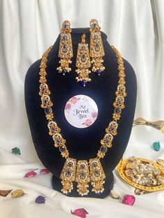 Add some sparkle to your special occasions with this stunning Indian/Pakistani Bridalwear Partywear Jewellery set from My Jewel Box. The set includes a Polki Zircon Long Dholna Mala Ranihaar, matching earrings and a tikka. The beautiful zircon gemstones are set in alloy metal and the set is made in Pakistan. It's perfect for engagements, weddings, anniversaries, birthdays, and Valentine's Day. The set features multiple natural gemstones with excellent cut grade and is perfect for those who love Festive Heavy Traditional Drape Sets, Festive Sets With Traditional Drape, Wedding And Navratri Stone Work Sets, Festive Heavy Semi-stitched Dupatta, Bollywood Style Sets With Kundan And Dabka, Heavy Bollywood Dupatta For Diwali, Festive Sharara With Stone Work For Eid, Bollywood Style Heavy Traditional Drape Sets, Heavy Traditional Drape Sharara For Festive Occasions