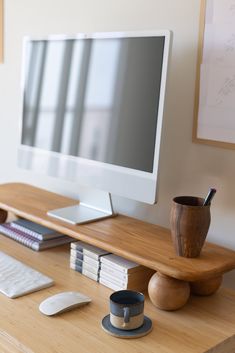 a computer monitor sitting on top of a wooden desk