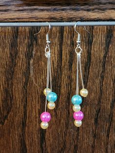 A fun pair of cascading dangle earrings that add flair to your look through . Wear as pieces to extenuate your individual personality or as flirty and fun accoutrements to complement your style! Trendy Dangle Linear Earrings, Dangle Pearl Earrings With Dangling Beads For Party, Trendy Dangle Linear Earrings For Party, Party Dangle Beaded Earrings, Trendy Tassel Earrings With Dangling Beads For Party, Trendy Party Tassel Earrings With Dangling Beads, Adjustable Dangle Pearl Earrings, Trendy Dangle Chandelier Earrings For Pierced Ears, Party Drop Earrings With Dangling Beads