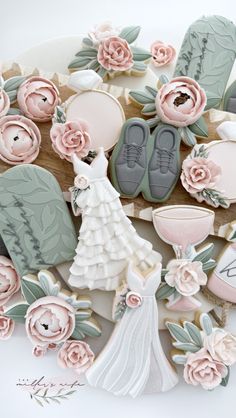 wedding cookies decorated with flowers and bride's shoes