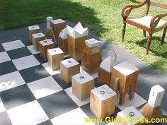 several pieces of wood sitting on top of a black and white checkerboard floor