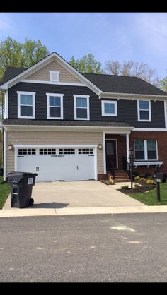 a large house with two garages in front of it