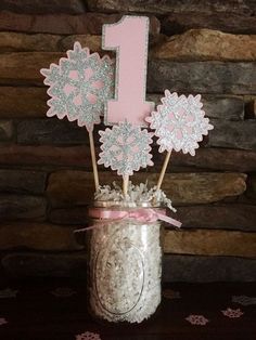 a cake topper is placed in a mason jar