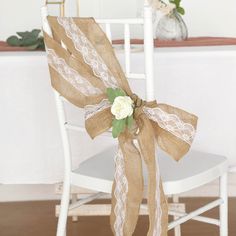 a white chair with a burlap bow tied to it