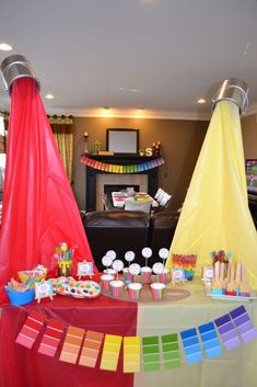 there is a table with cupcakes and candy on it in the living room