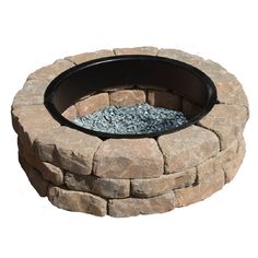 a stone fire pit with gravel around it